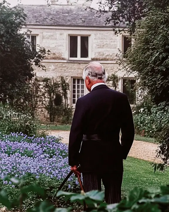 portrait of the King Charles III in a garden with borage plants