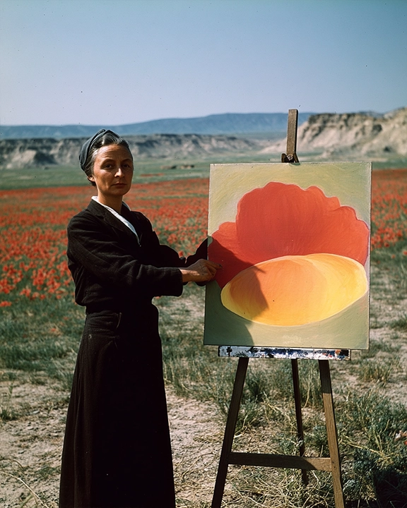 georgia o'keeffe in front of a poppy painting