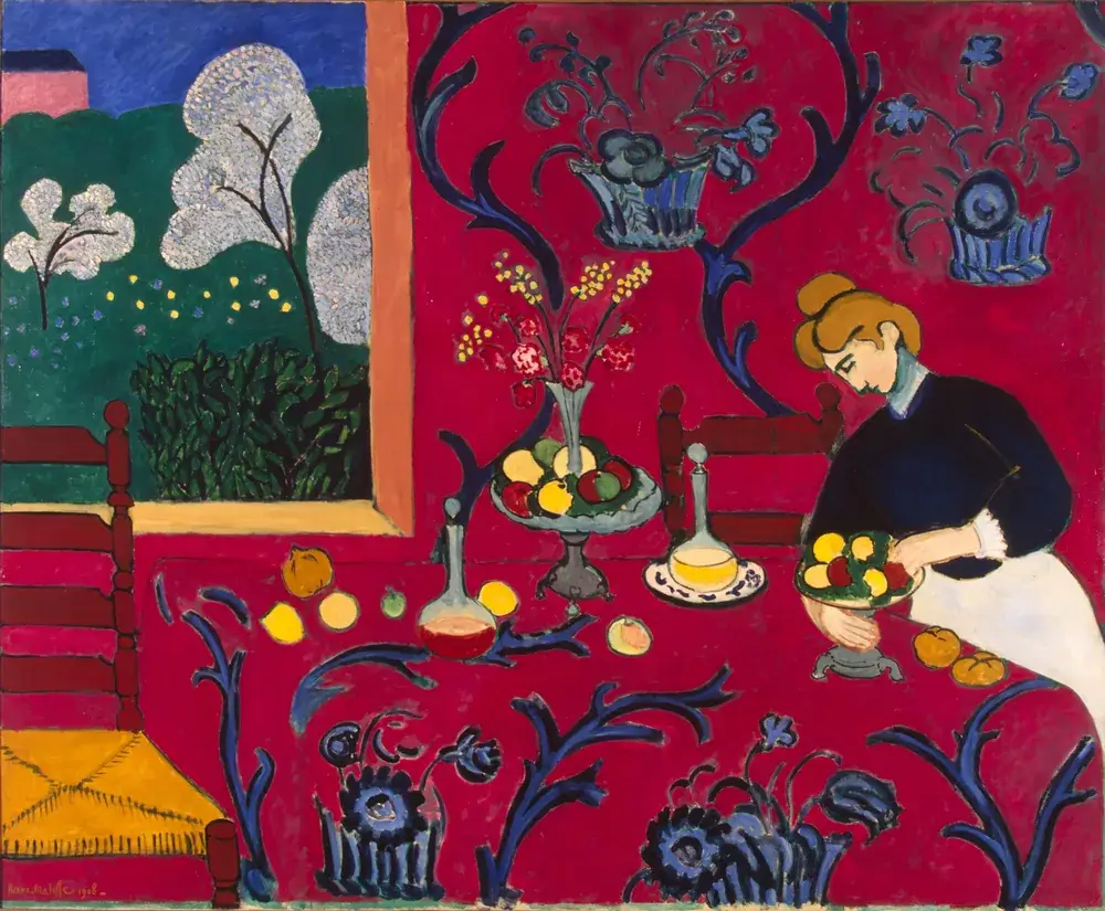 Henri Matisse, Harmony in Red: a woman arranging fruit on a red table against a red wall patterned with blue arabesques, and a window onto a green garden